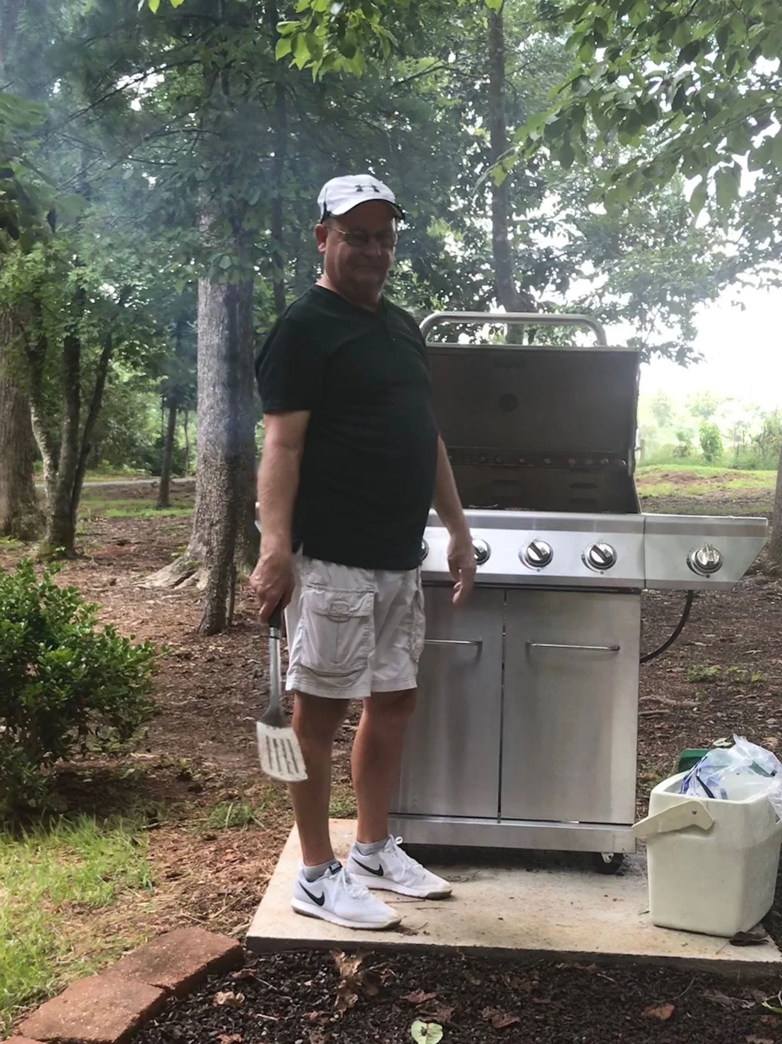 Tom Hickle cooking the burgers and hot dogs for us.