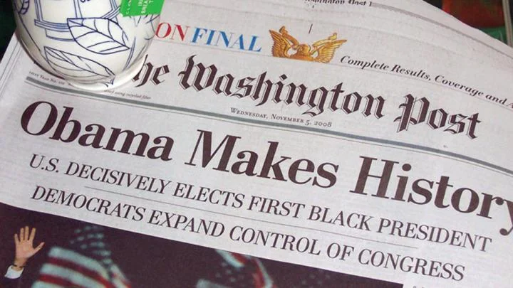Pots in Action photo of Julia Galloway’s Obamaware cup with the historic front page of The Washington Post.