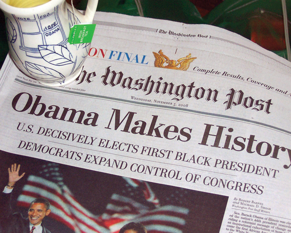 Pots in Action photo of Julia Galloway’s Obamaware cup with the historic front page of The Washington Post.