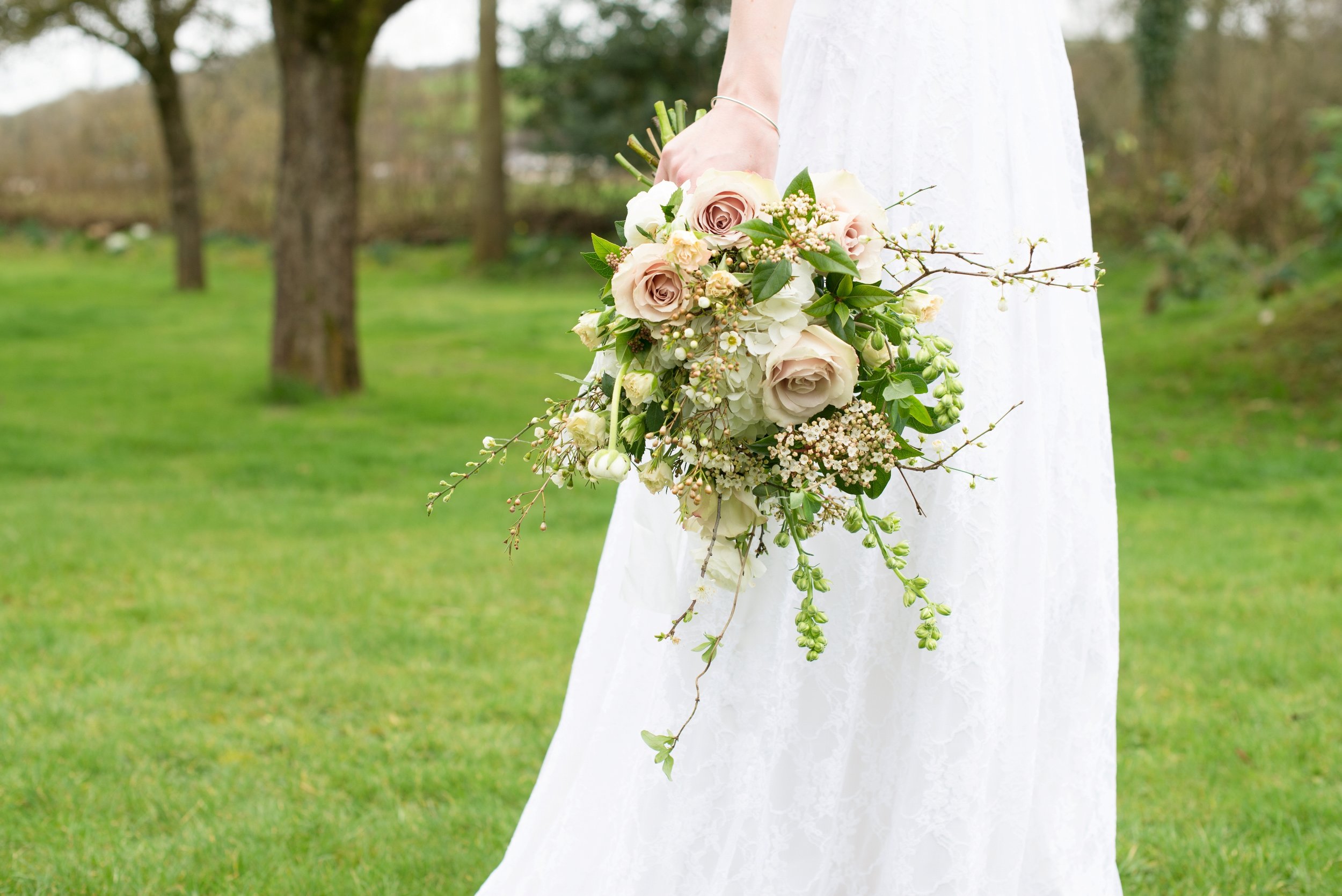 Spring bridal bouquet with roses and blossom in soft pinks and whites