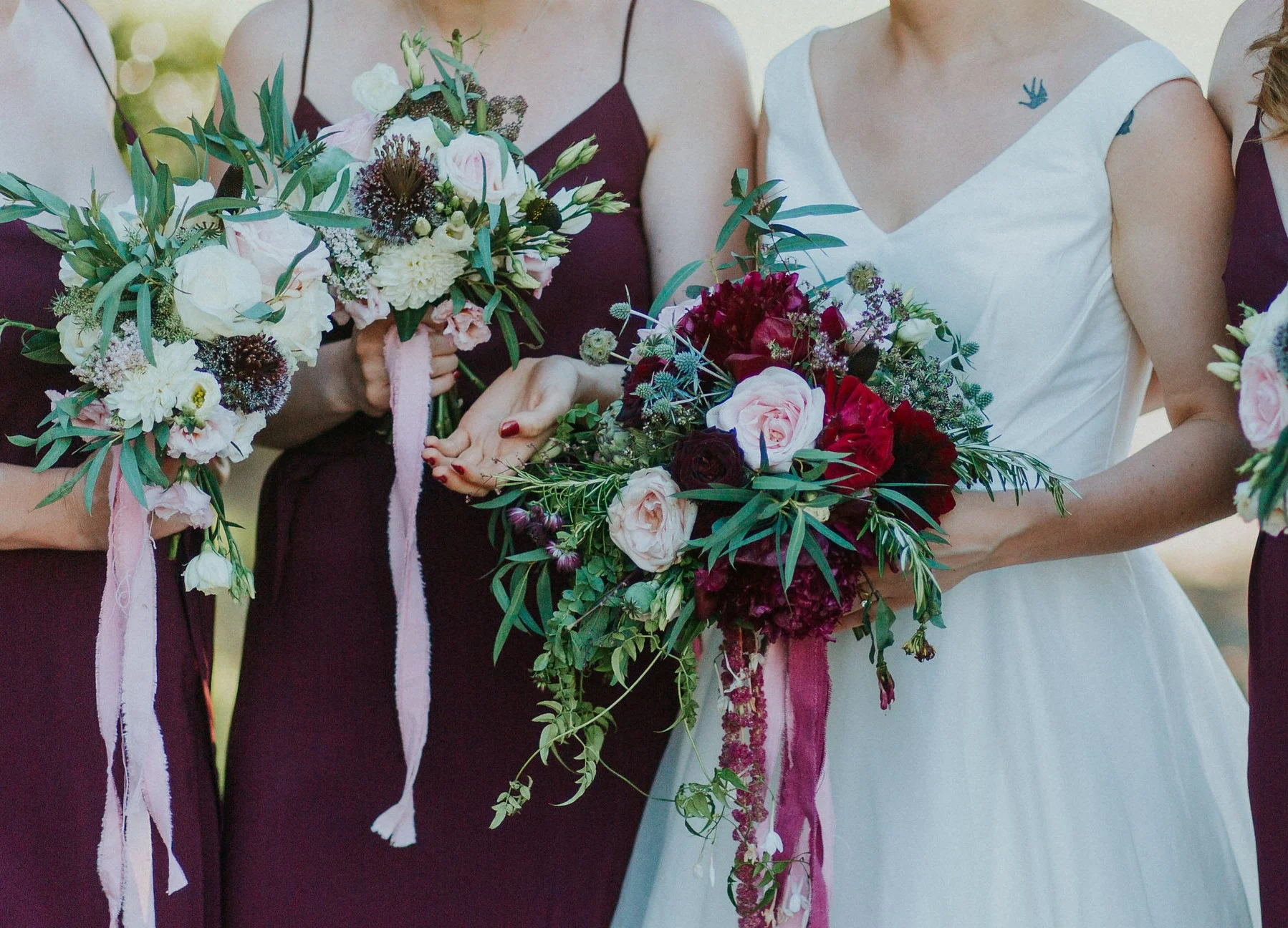 The dark burgundy of these alliums in the bridesmaid's bouquets added a great contrast again the pale flowers. Photo from Nathan English Photography