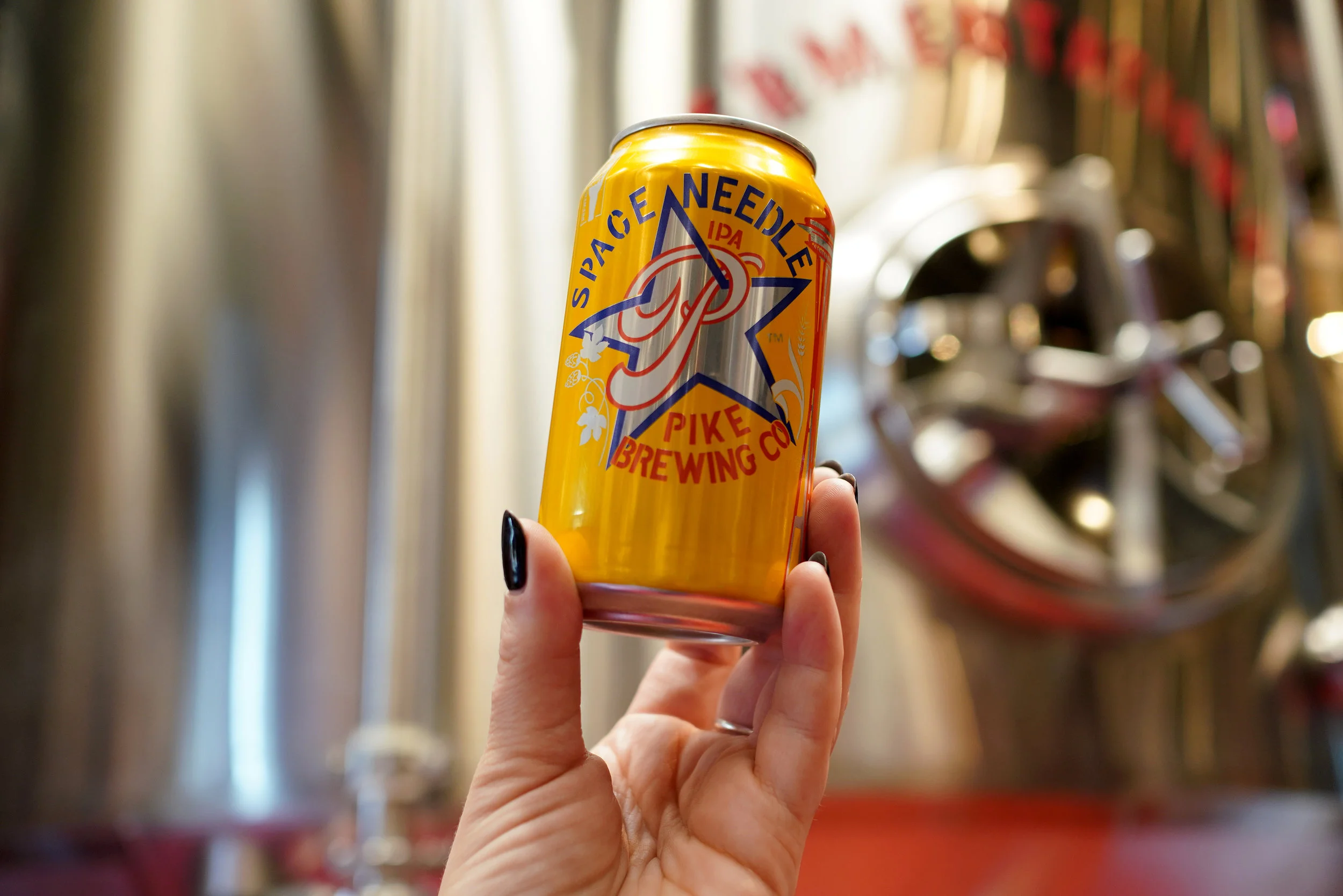 Pike Space Needle IPA in front of brewery tanks
