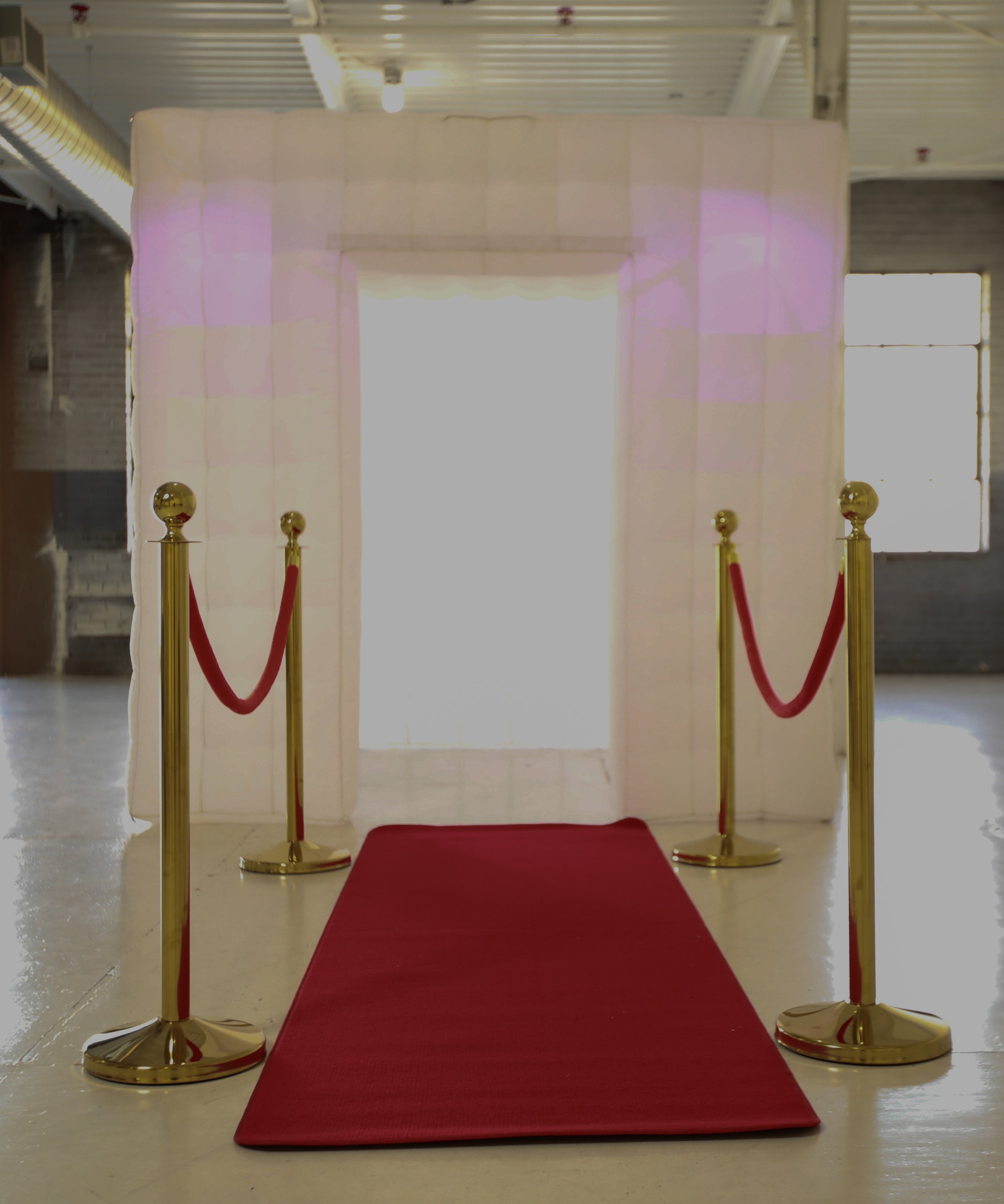 inflatable with red carpet & stanchions.jpg