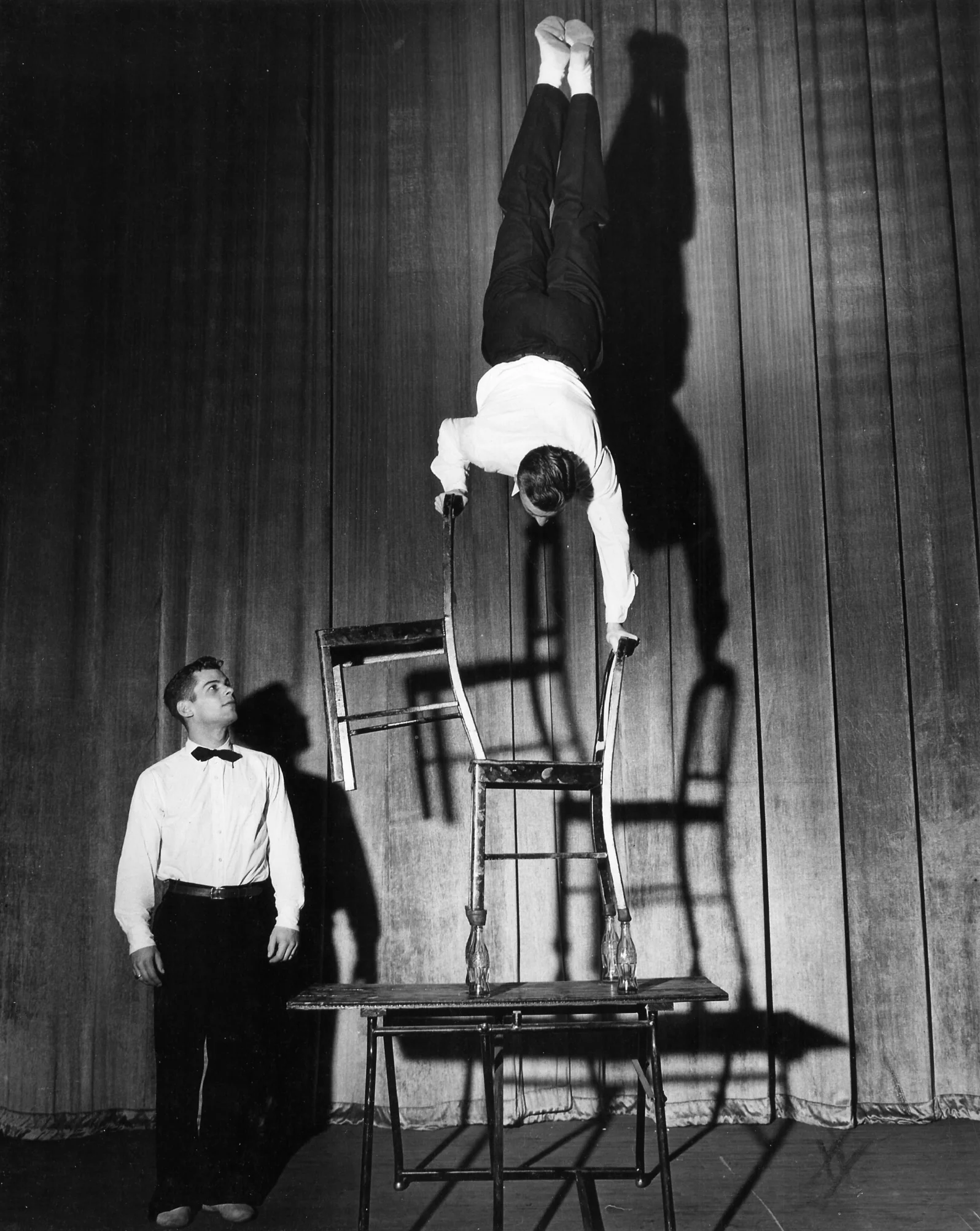 Gymkana 1949 illusion handstand on bottles performed by Al Kuckhoff, observed by Tom Bolgiano