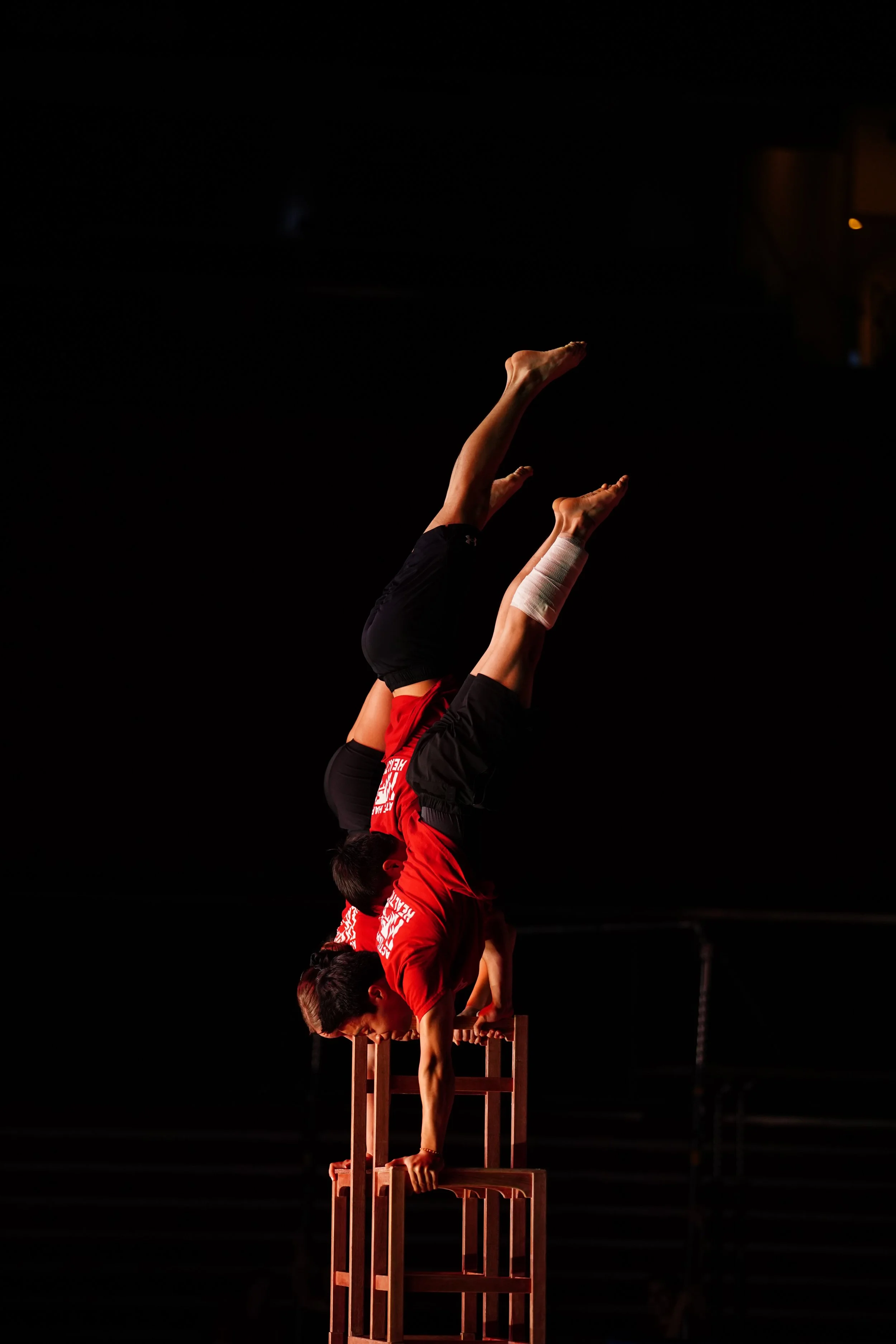  Teaghan Doran, Tyler Ostrowski, Javier Lorenzo handstand on chairs 