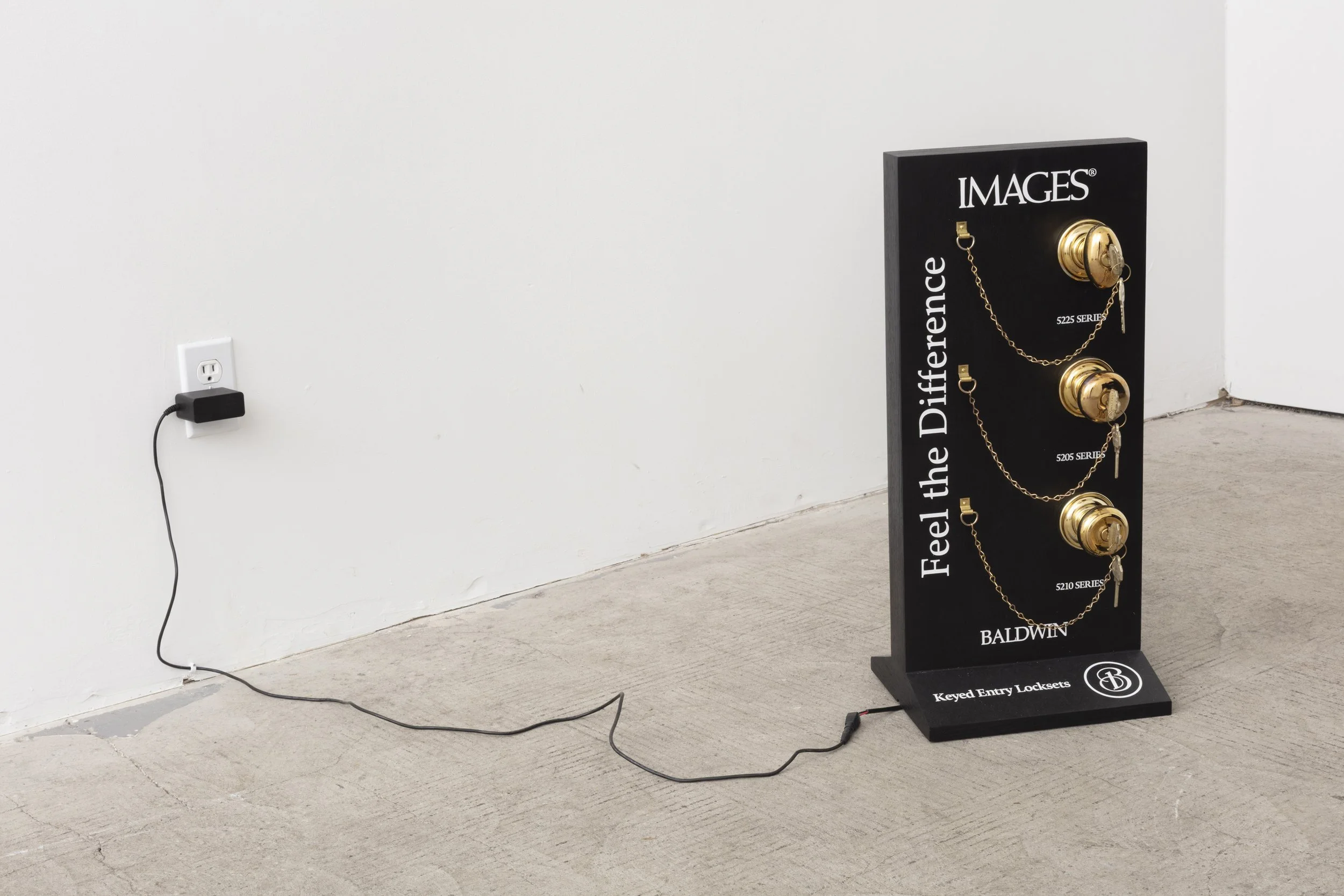   Images   2025  Images by Baldwin doorknobs, steel, wood, ink, lacquer, and motor  9 x 10.75 x 24 inches 