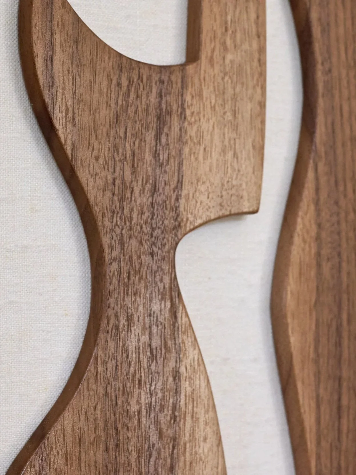 Detail view of handcrafted walnut guitar sculpture