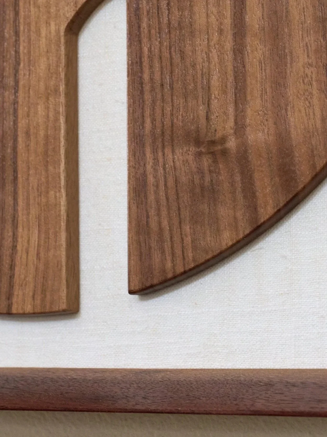 Detail view of handcrafted walnut guitar sculpture