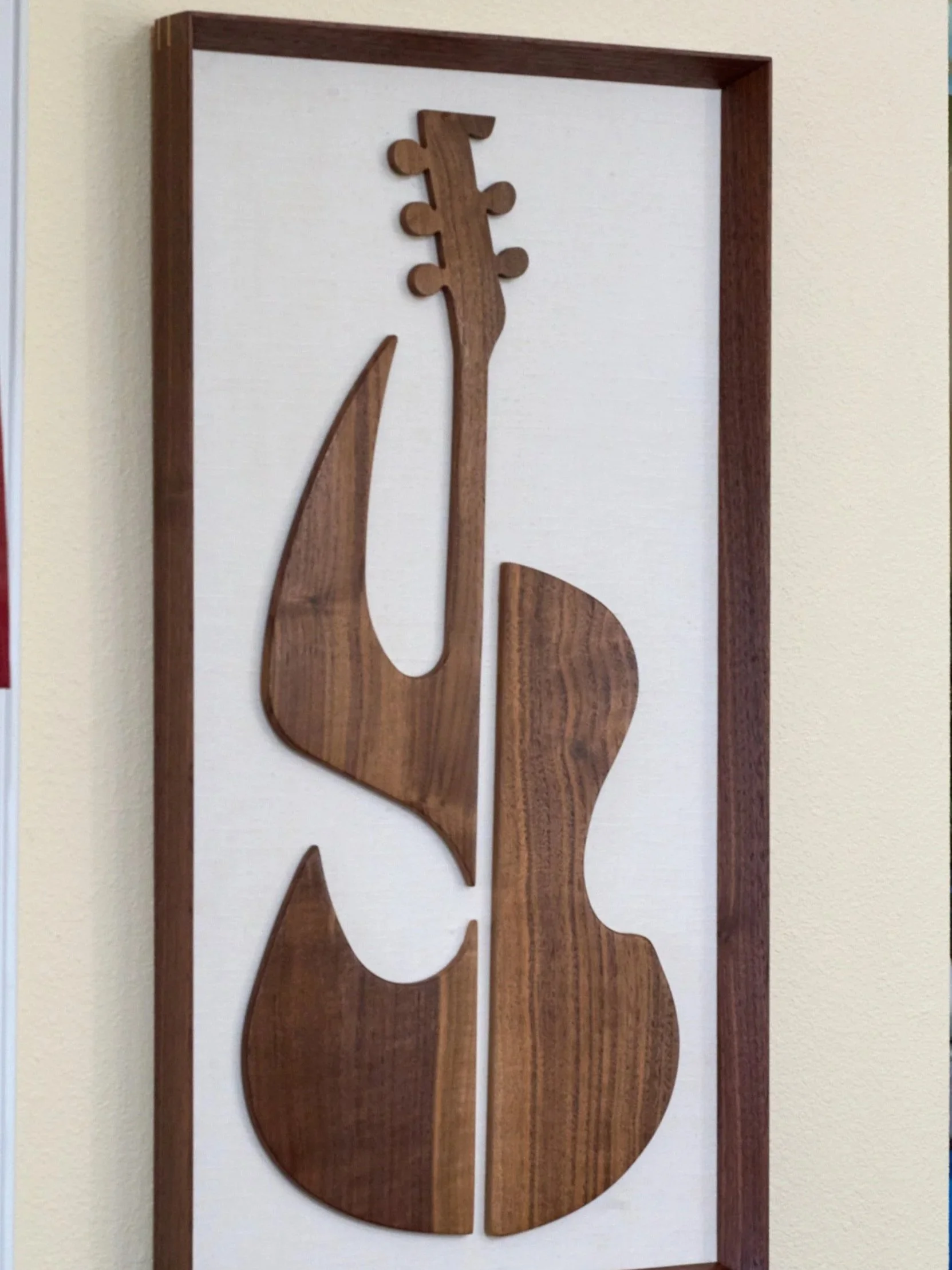 Abstract walnut guitar wall sculpture in portrait orientation