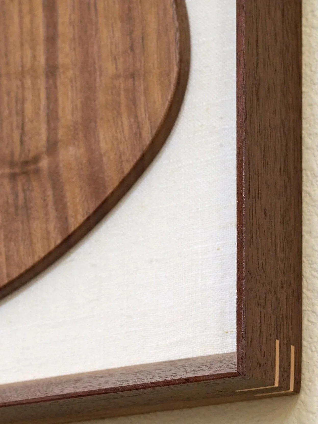 Detail view of handcrafted walnut guitar sculpture