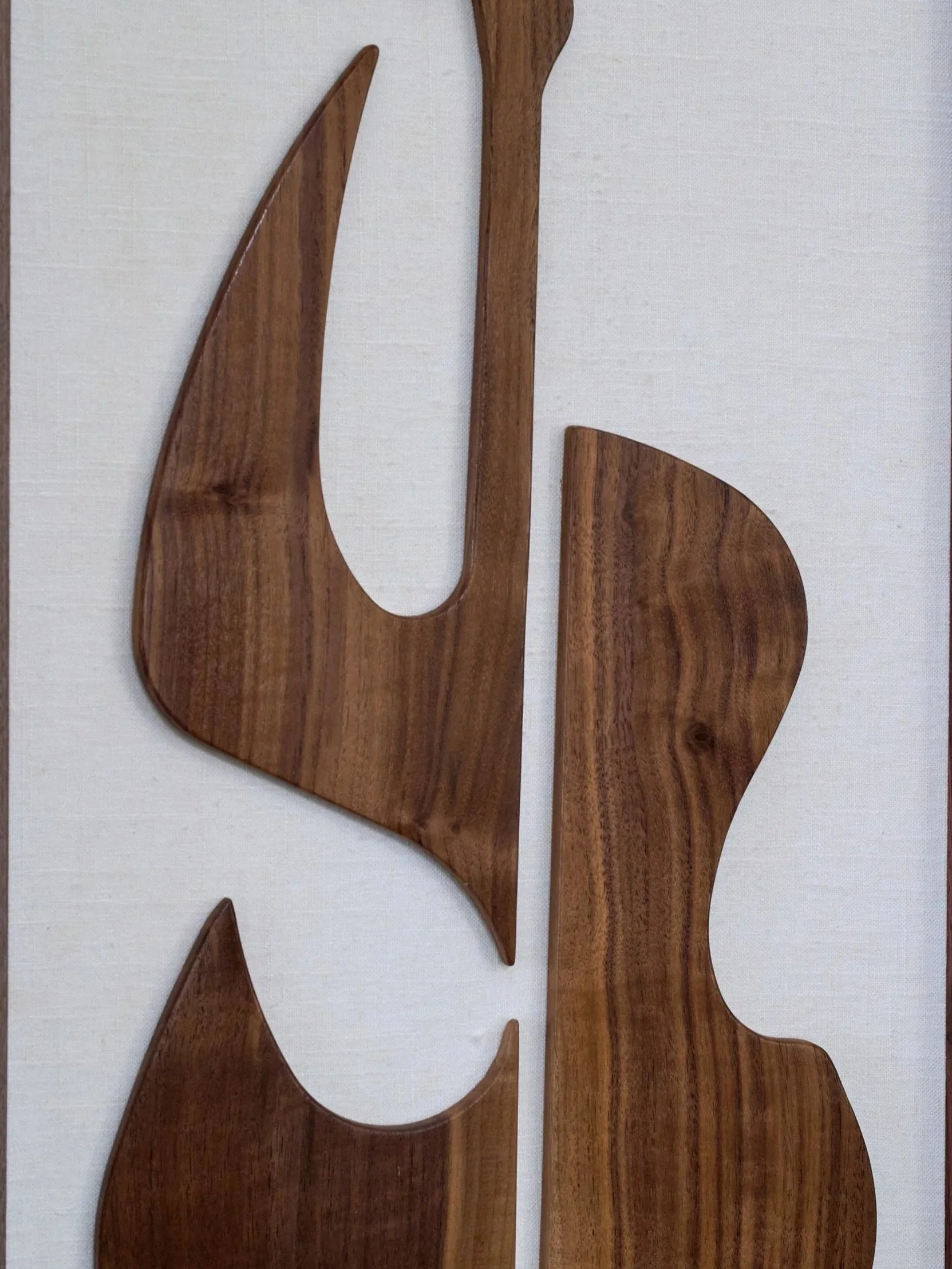 Detail view of handcrafted walnut guitar sculpture