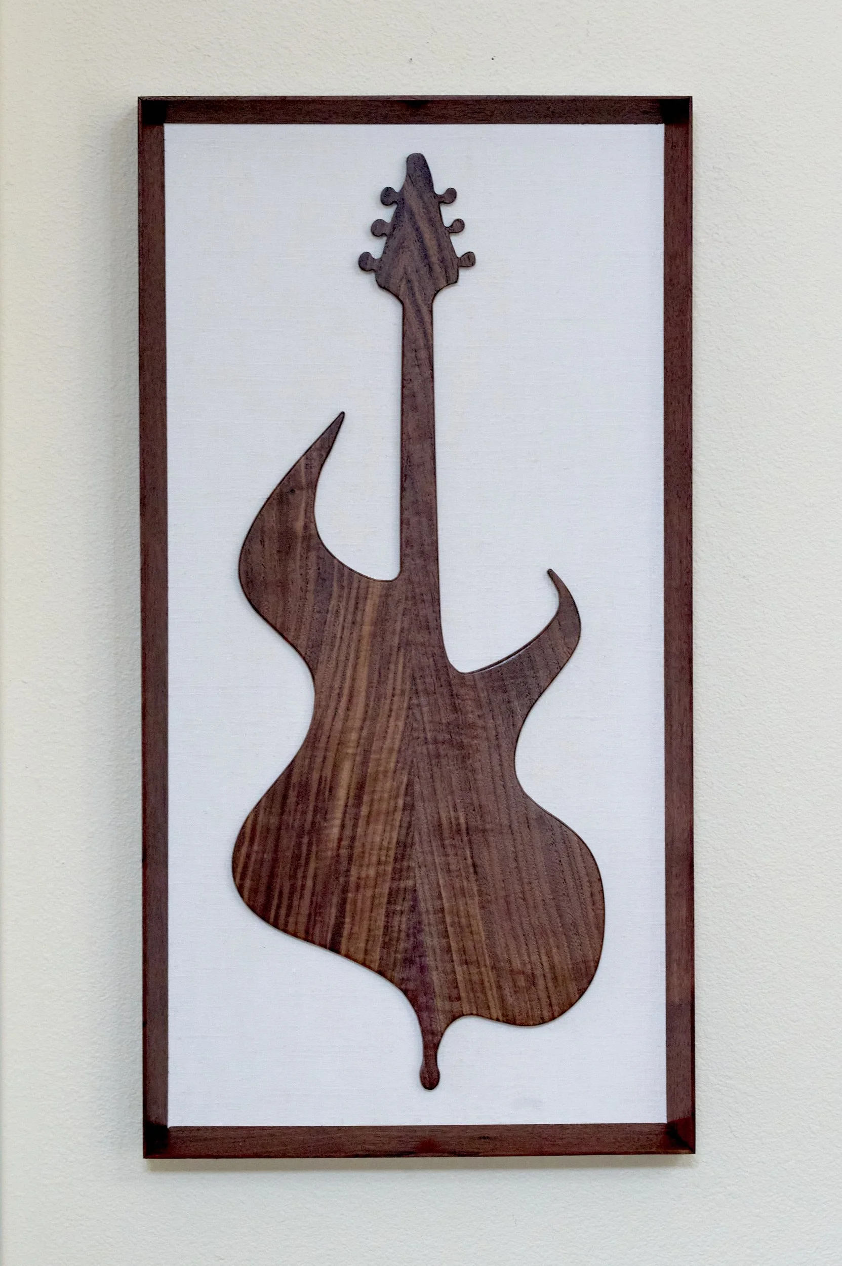 Abstract walnut guitar wall sculpture in portrait orientation
