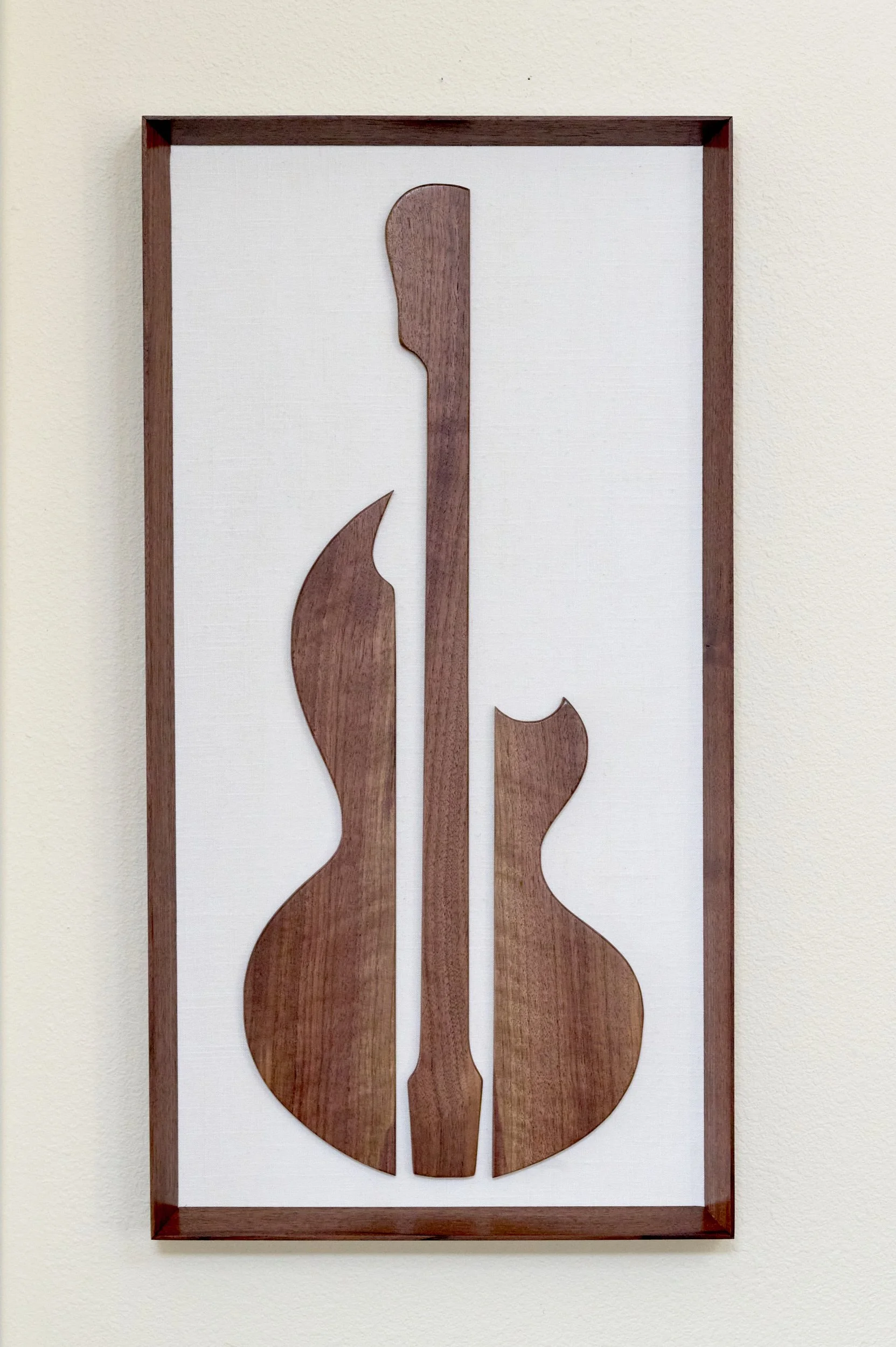 Abstract walnut guitar wall sculpture in portrait orientation