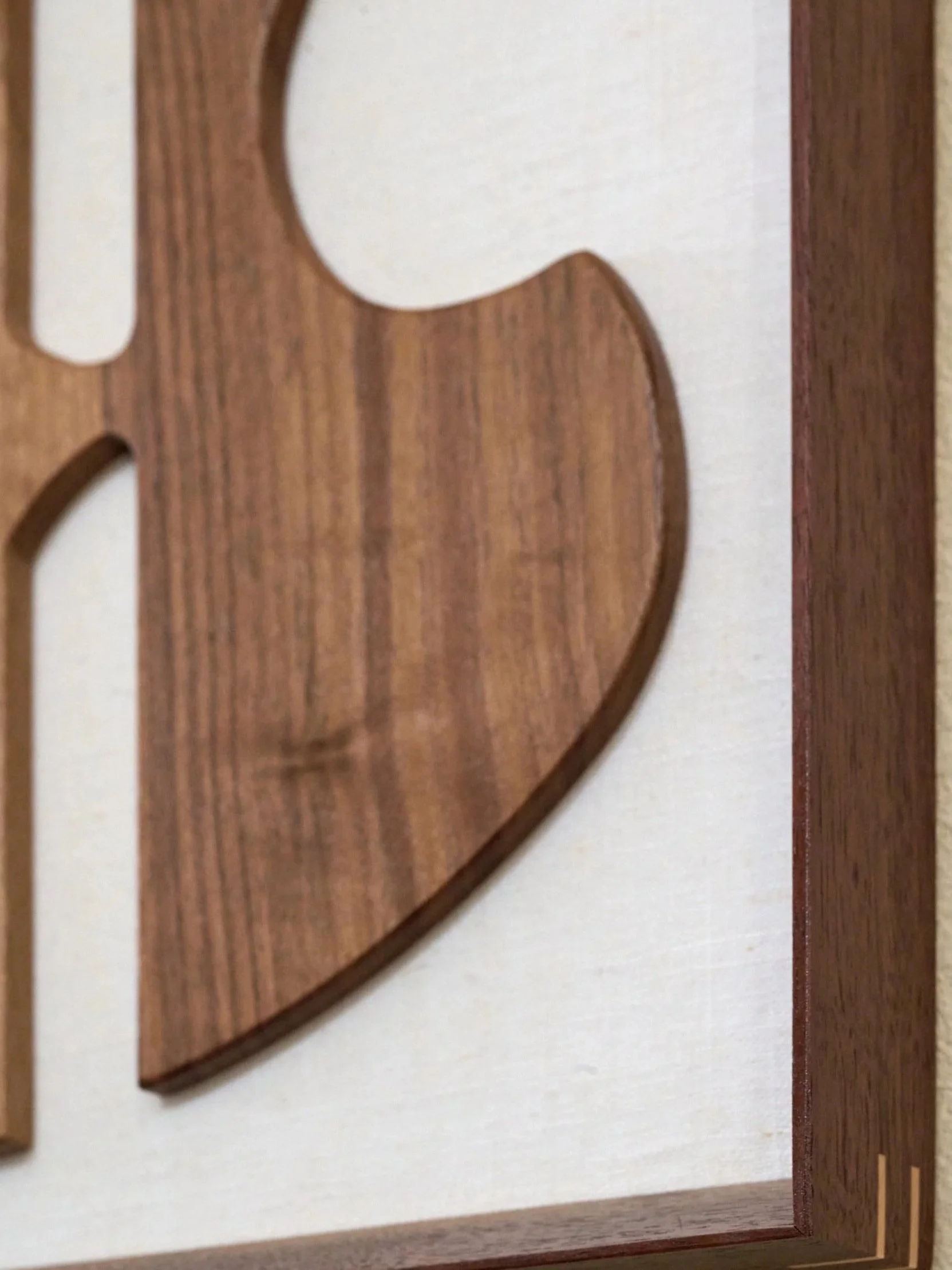 Detail view of handcrafted walnut guitar sculpture
