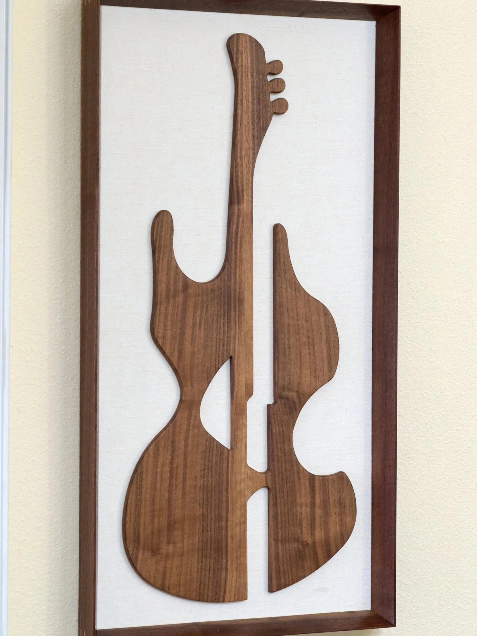 Abstract walnut guitar wall sculpture in portrait orientation