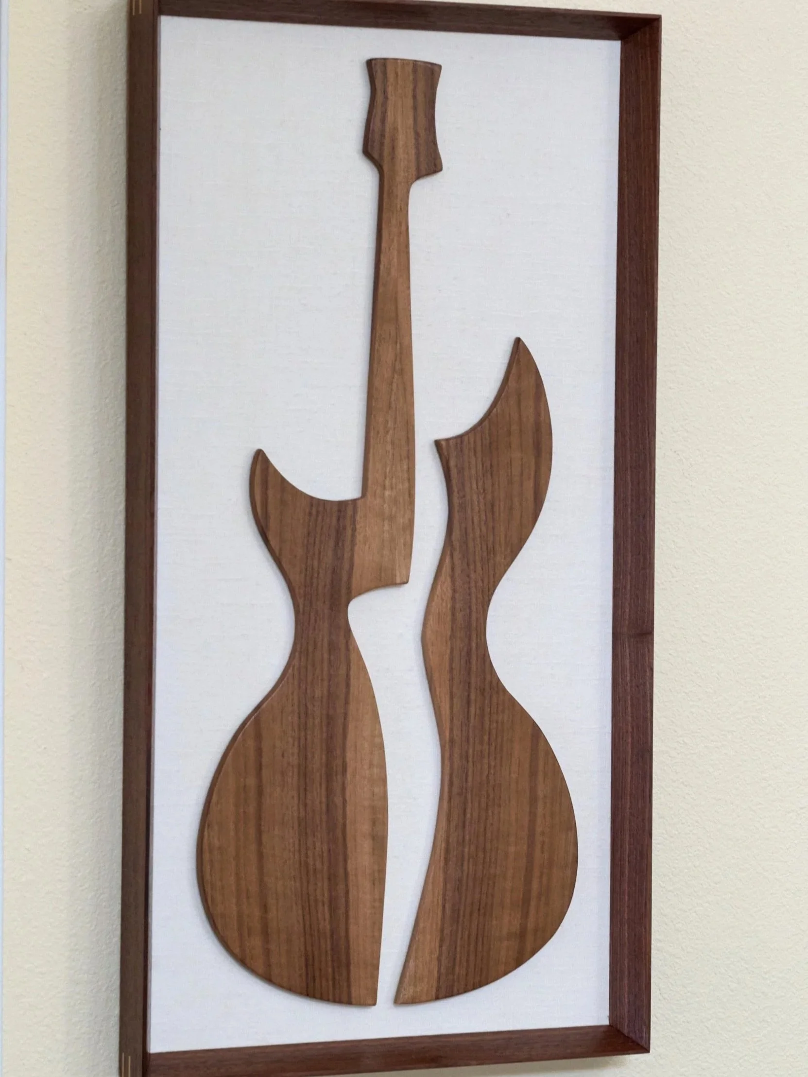 Abstract walnut guitar wall sculpture in portrait orientation
