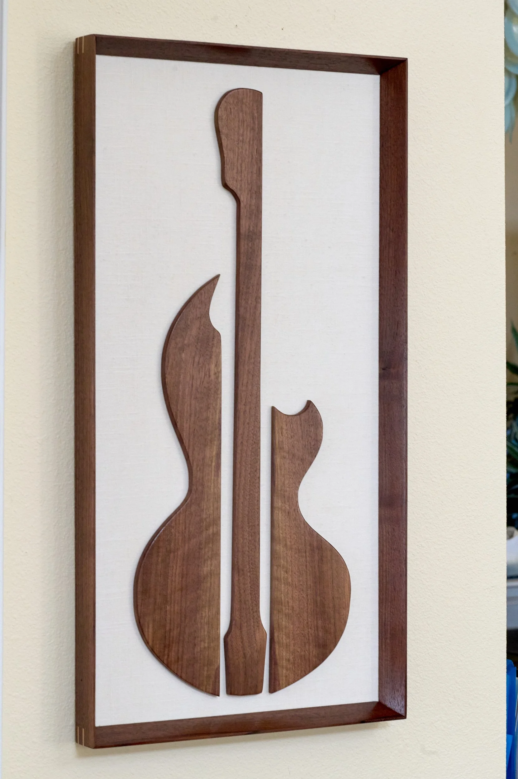 Detail view of handcrafted walnut guitar sculpture