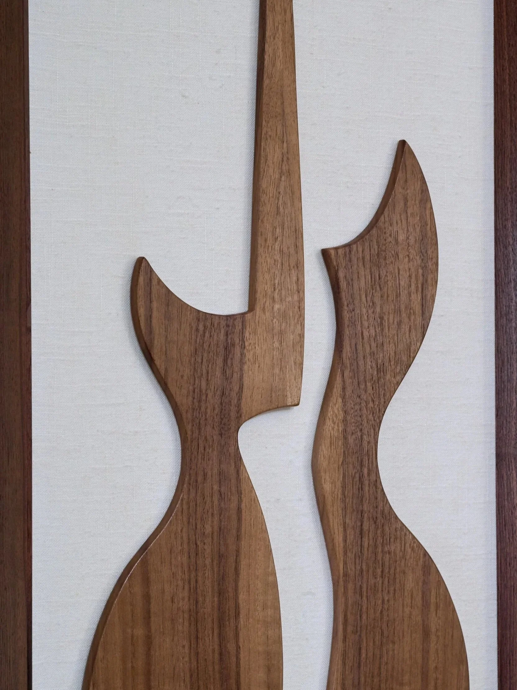 Detail view of handcrafted walnut guitar sculpture