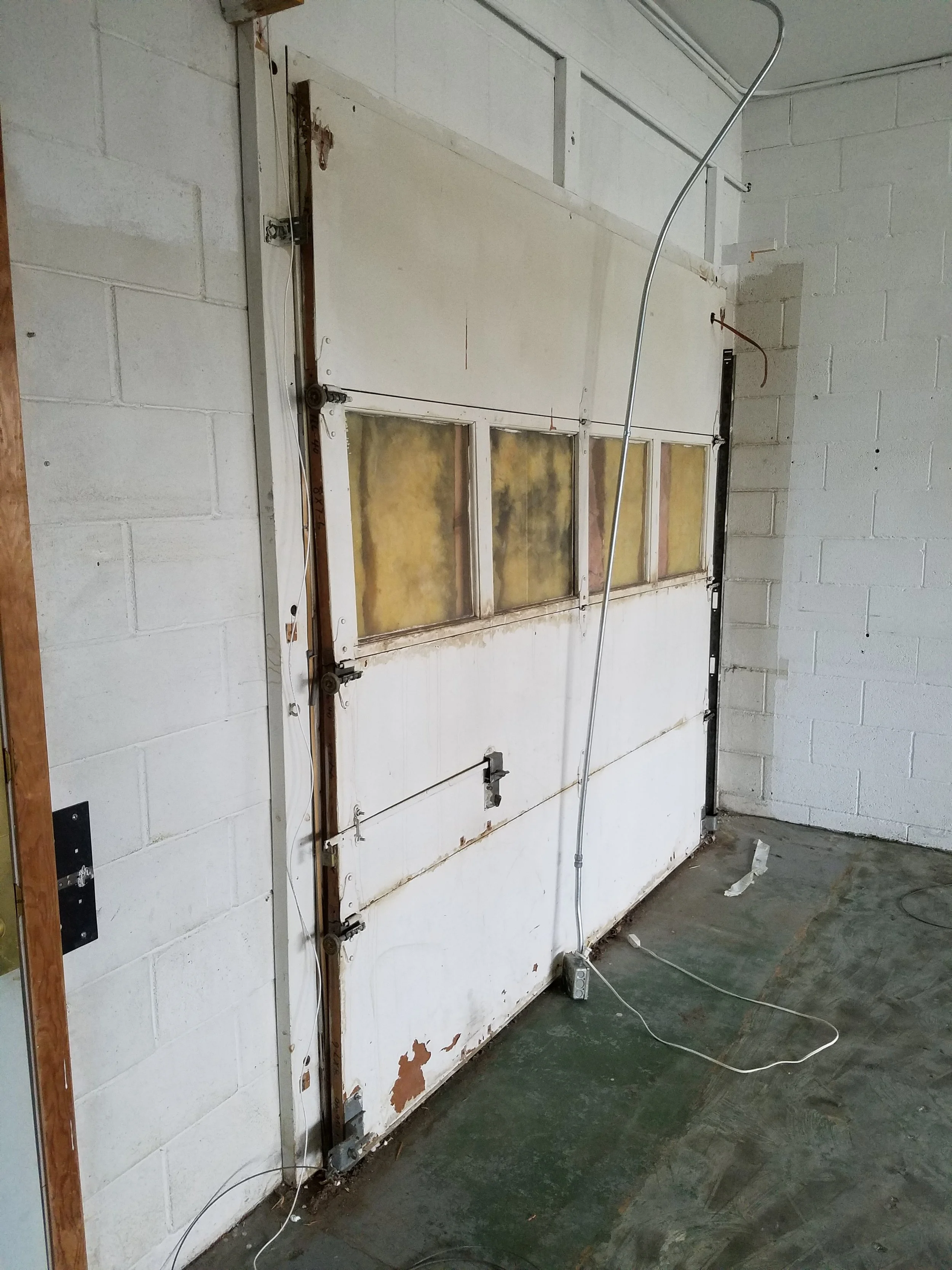 This had been covered in by a simple wall the tenant had built. We'll either replaced it with a new door or we will block in as appropriate.