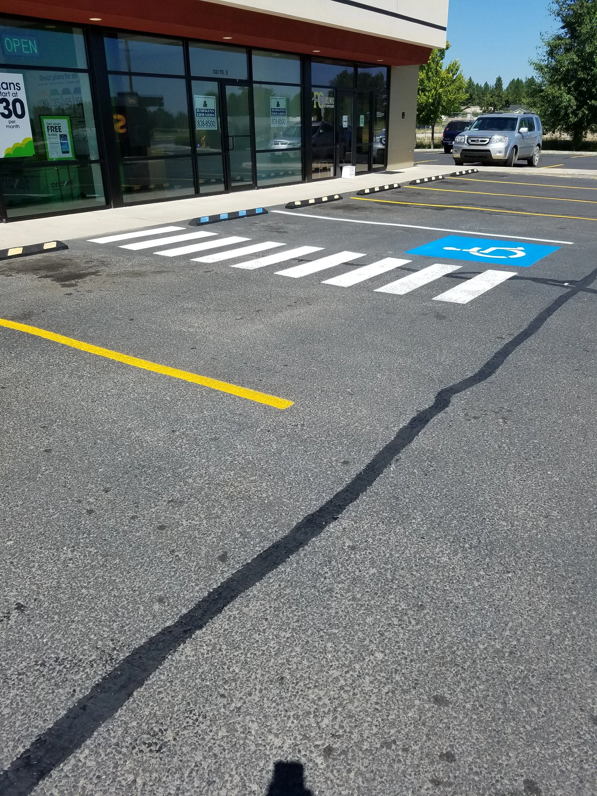 New parking lot striping with some crack sealant