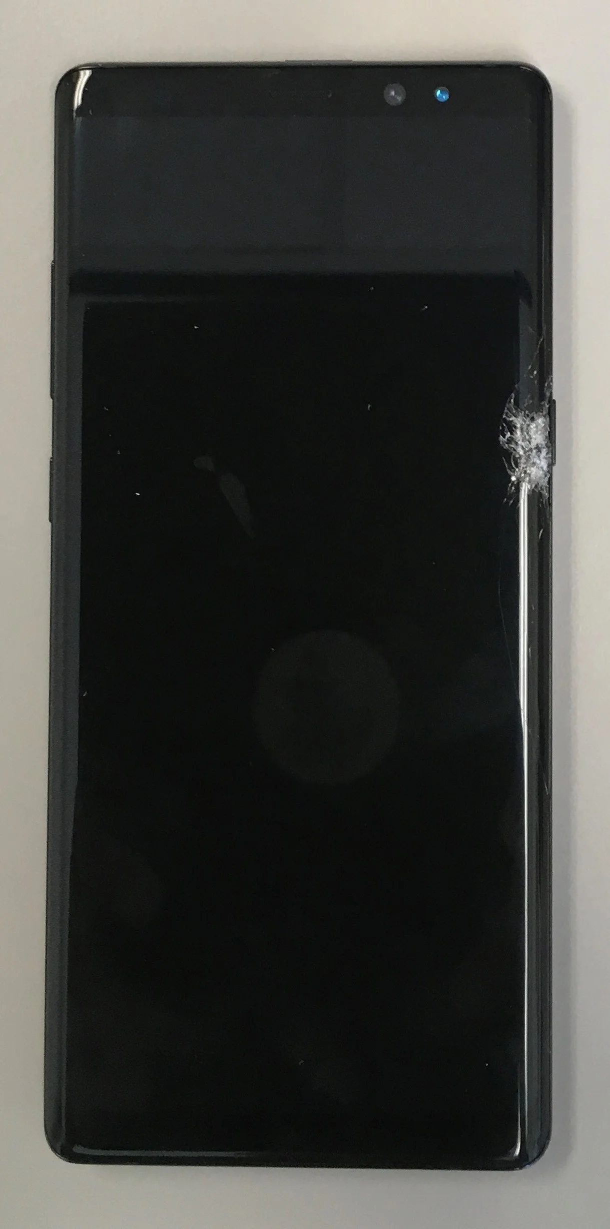 The edge was completely crushed near the power button. game over, man.