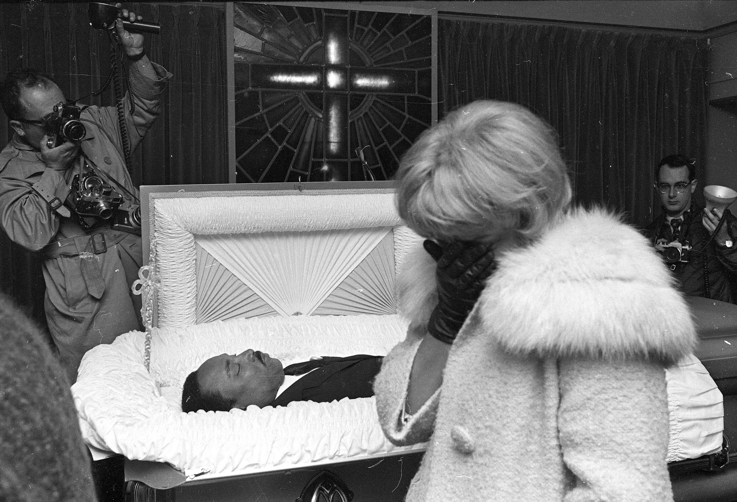 PAGE 114: DR. KING WAS ASSASSINATED ON APRIL 4, 1968. BEFORE THE SLAIN CIVIL RIGHTS LEADER'S BODY WAS RETURNED TO ATLANTA, A FUNERAL WAS HELD FOR MOURNERS IN MEMPHIS, TENNESSEE. AN UNIDENTIFIED WOMAN CONCEALS HER FACE AS SHE GRIEVES OVER THE LOSS OF THE CIVIL RIGHTS LEADER (PERMISSION OF THE ASSOCIATED PRESS).