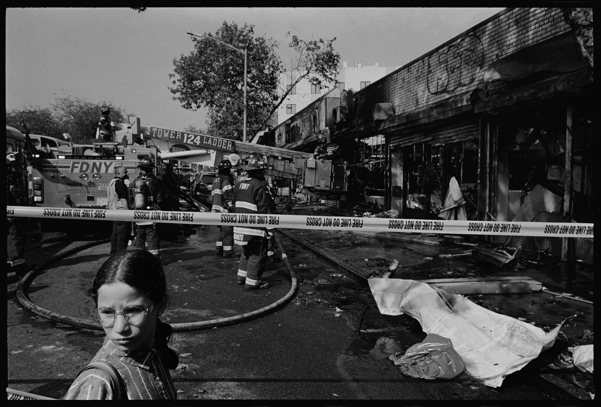 Girl in front of burned buildings, Williamsburg St E