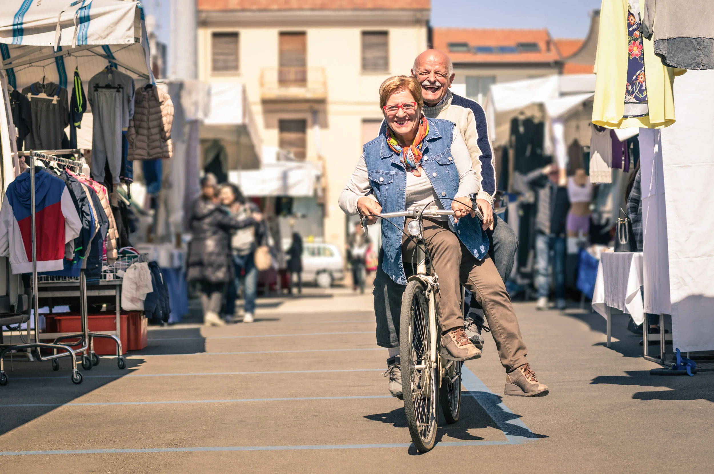 stock-photo-happy-senior-couple-having-fun-with-bicycle-at-flea-market-concept-of-active-playful-elderly-with-274716779.jpg