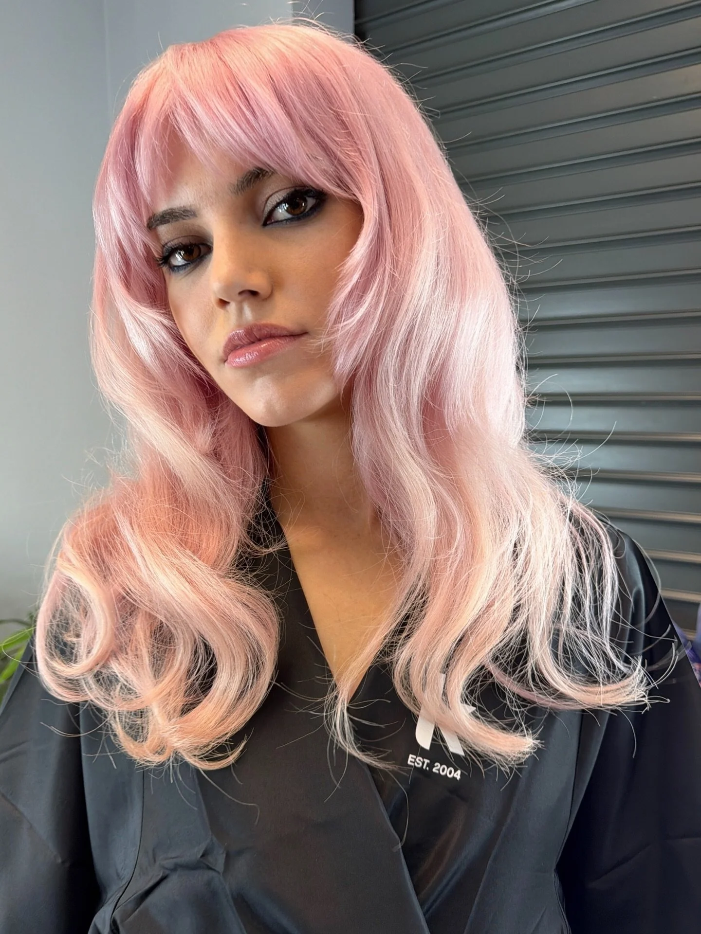 THE MOST WEARABLE PINK

This tone is created by layering a soft diluted red pigment over clean, even pre-lightened hair. The key is controlled lift. A balanced mix of warm and cool reflects gives it that neutral, diffused finish.

Using GLOSS 1p 7.65