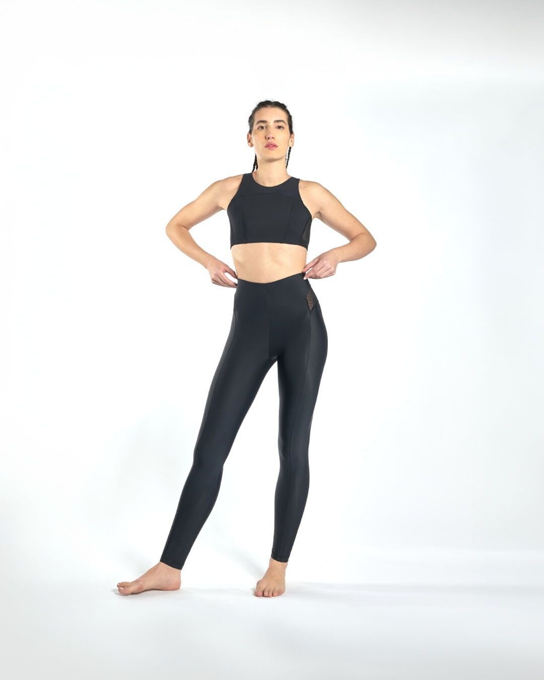 CAROLINA wears the Empowering Top + the Boundless Leggings in black. Discover all the available shades of our most loved set on UNDSWIM.COM. #undswim #sustainablefashion #lifewear #undverse #sportystyle #activewear