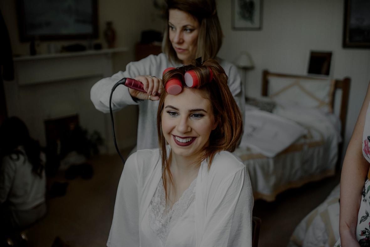 bride is getting hair done