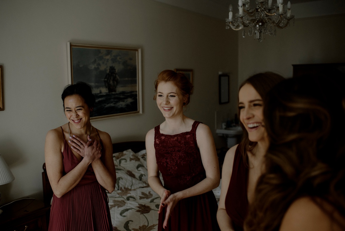 bridesmaids are admiring bride