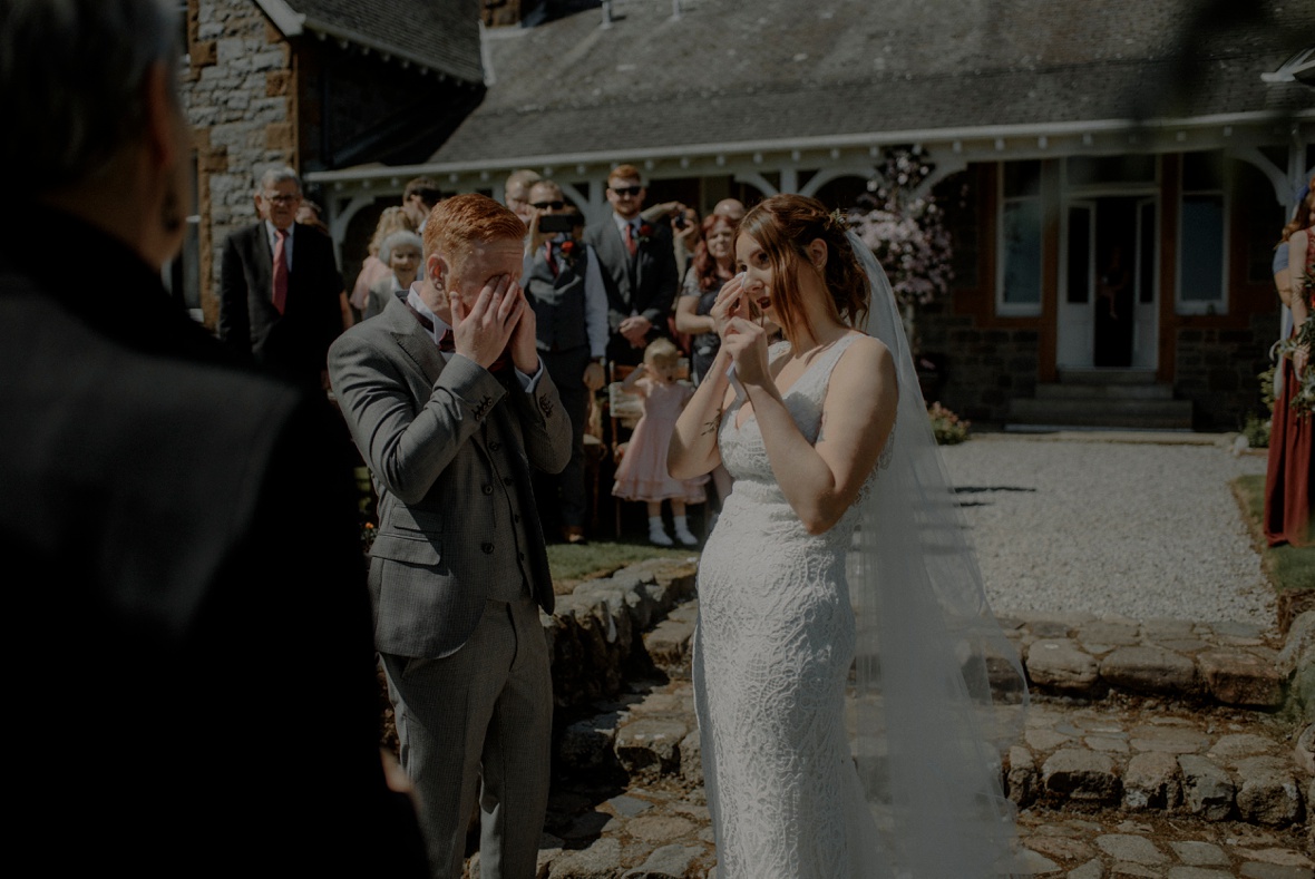 couple is crying at ceremony