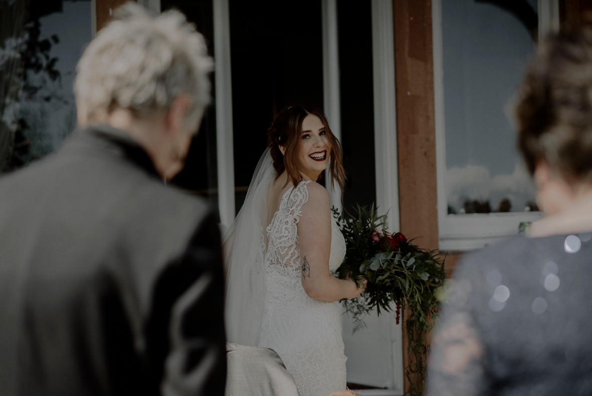 bride is looking back and laughs