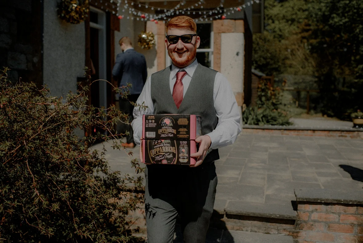 guy carrying box of beer