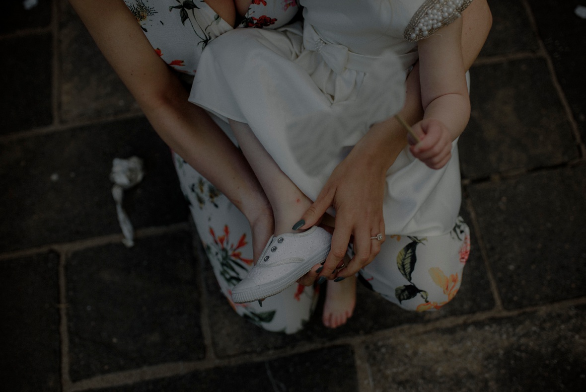 little girl is putting shoe on