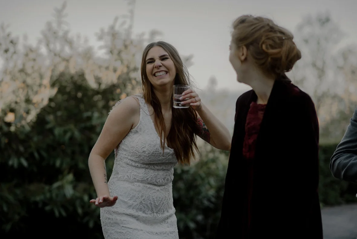 bride is dancing with drink in hand