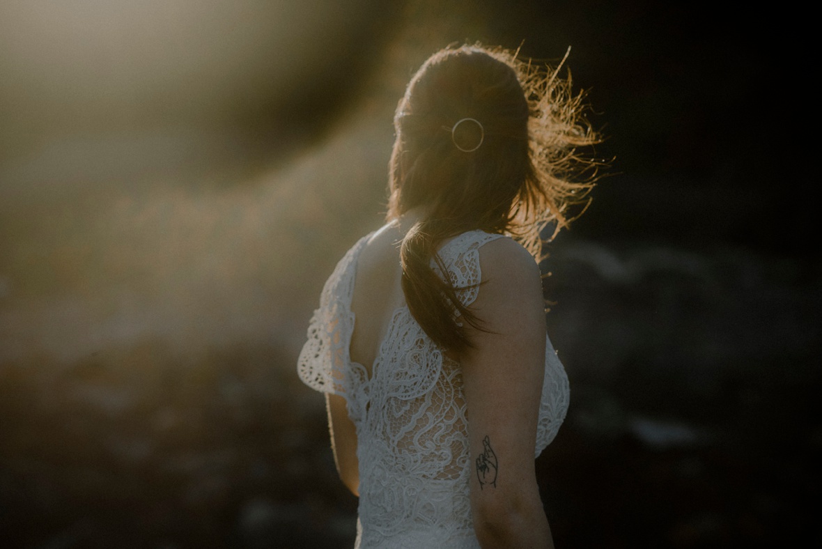 golden evening light is falling onto bride's hair