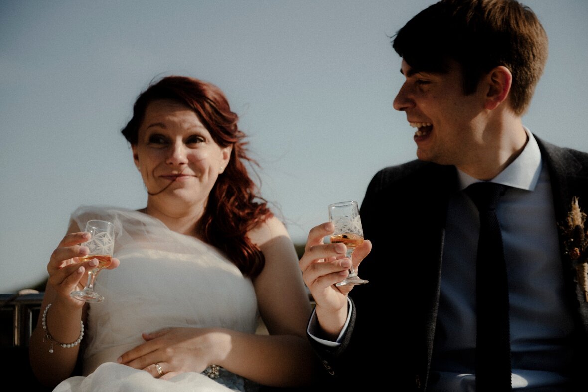 bride and groom raise the toast