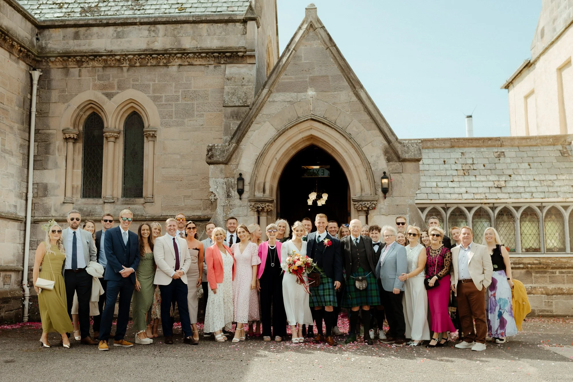 family group wedding in front of the church photographs