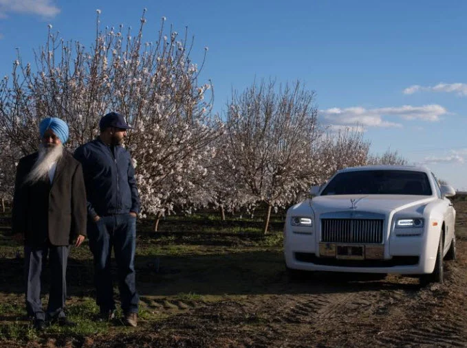 Almond grower Daljit Rakkar (right) is helping run the Central Valley business established by his father, Gurcharan (left), who got his start in almonds as a farm laborer. Half the Rakkars’ 2,000 acres are planted with almonds, and the rest with a mix of pistachios and raisins. PHOTOGRAPH BY LUCAS FOGLIA, NATIONAL GEOGRAPHIC