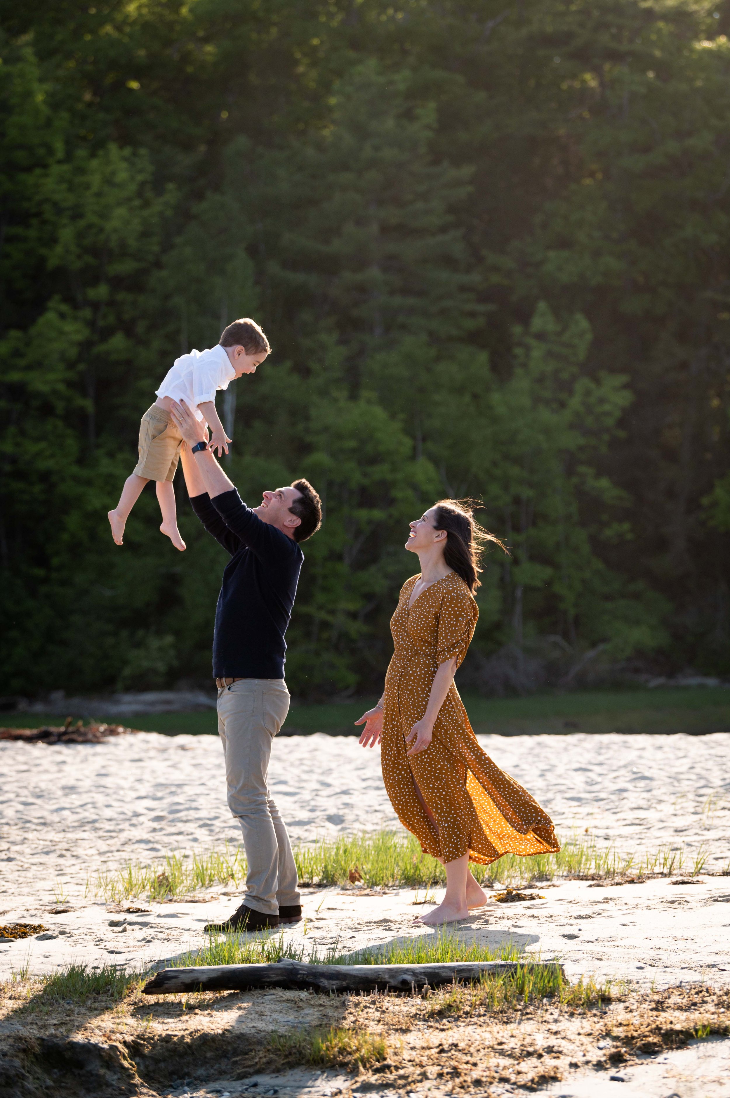 lindsay murphy photography | portland maine family photographer | family throwing son up in air at beach in cumberland.jpg