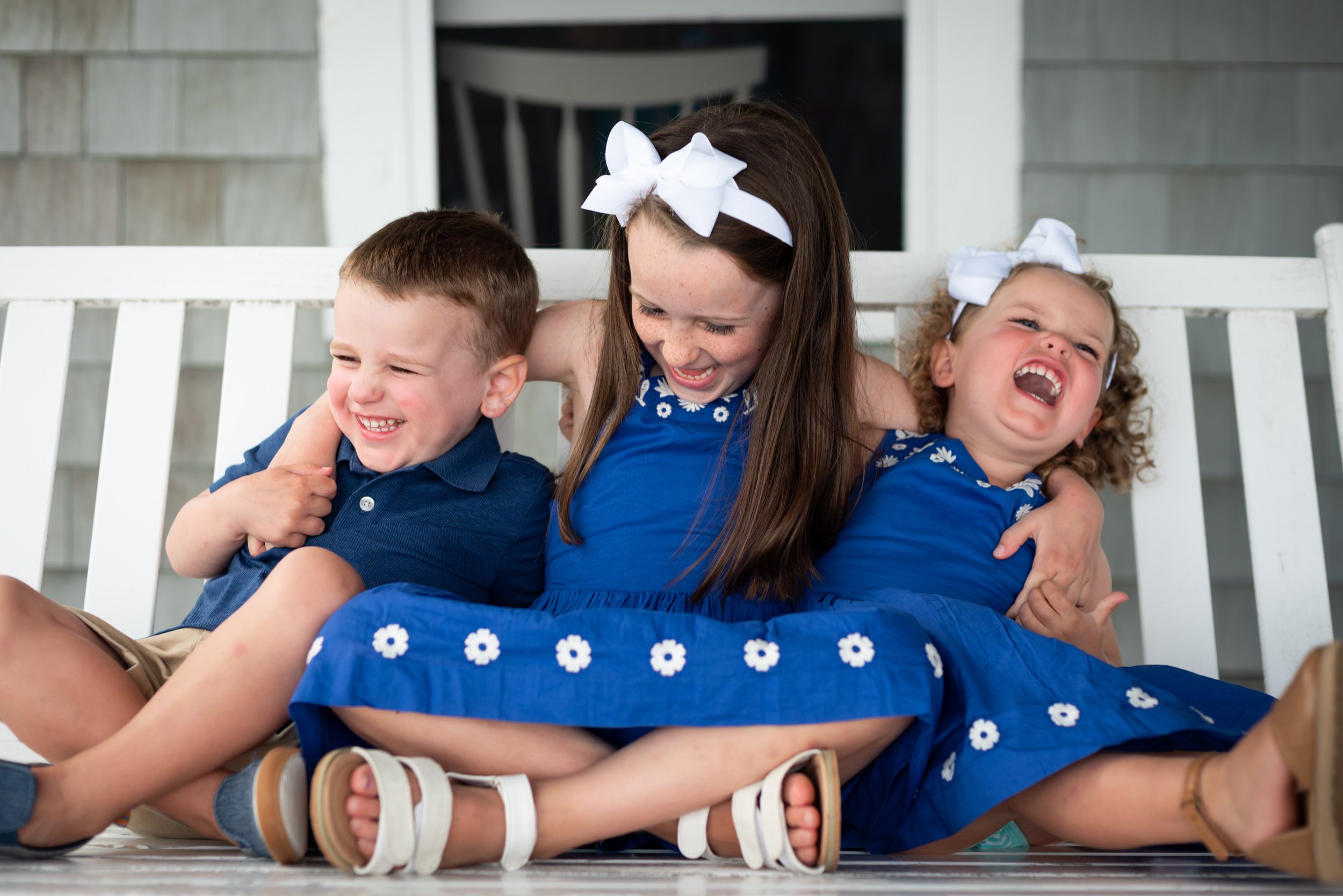 lindsay murphy photography | portland maine family photographer | siblings on porch swing chebeague island.jpg