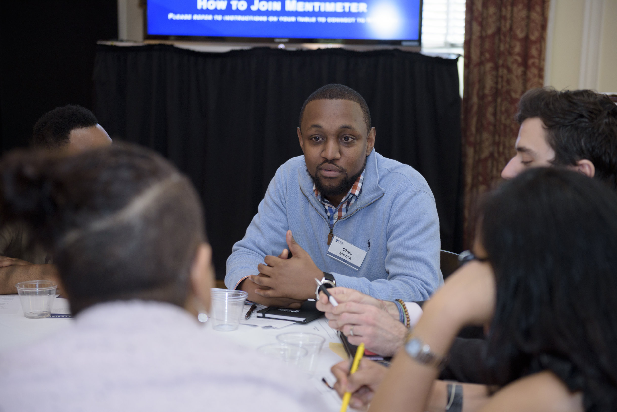 Chas Moore, executive director and founder of Austin Justice Coalition, in small group discussion.