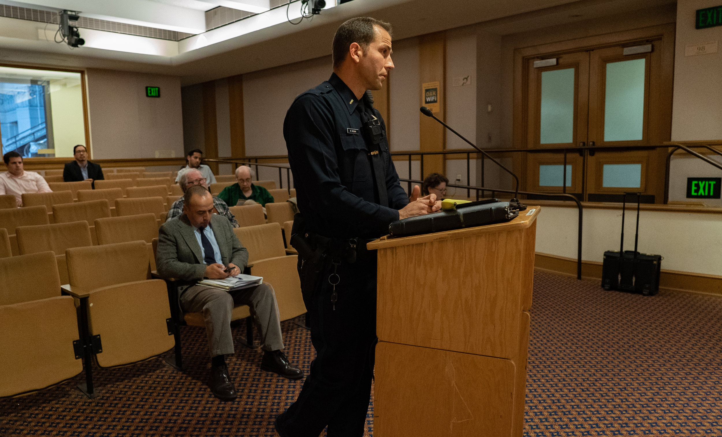  An Oakland Police Department officer speaks on the benefits of automated license plate readers before the Commission.  