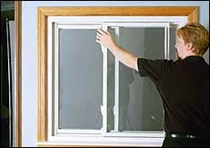 Hold sash secure and stable with one hand while using other to fully pull down top latch lever, releasing top brake.
