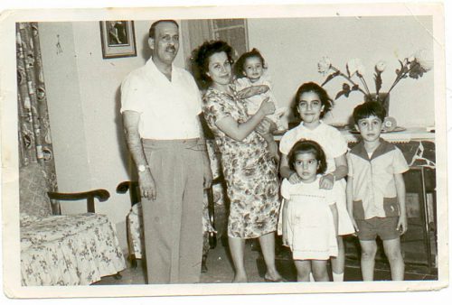 Cynthia as a baby in her mother’s arms, her father and three siblings in their home in Baghdad