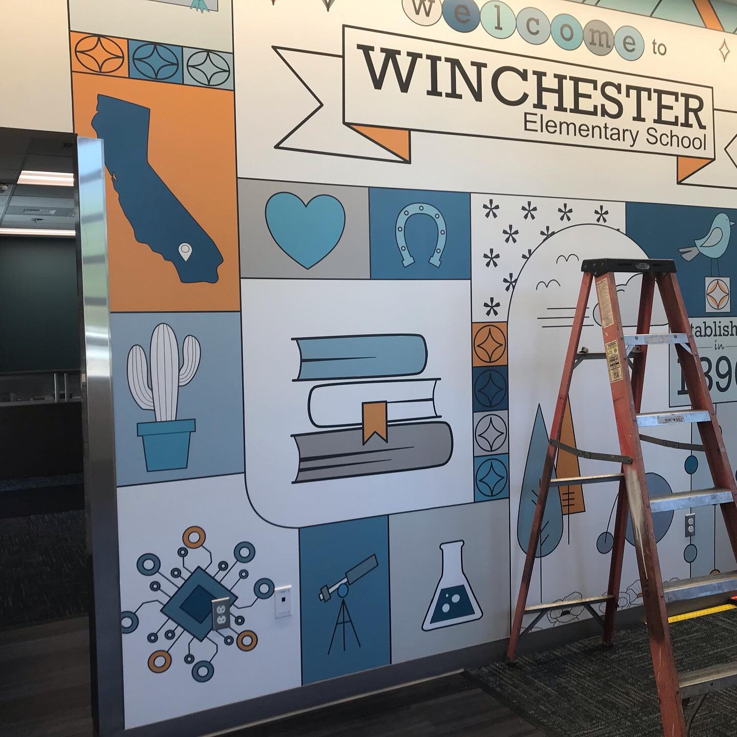 Wall art installation progress @ reception counter - Winchester Elementary School