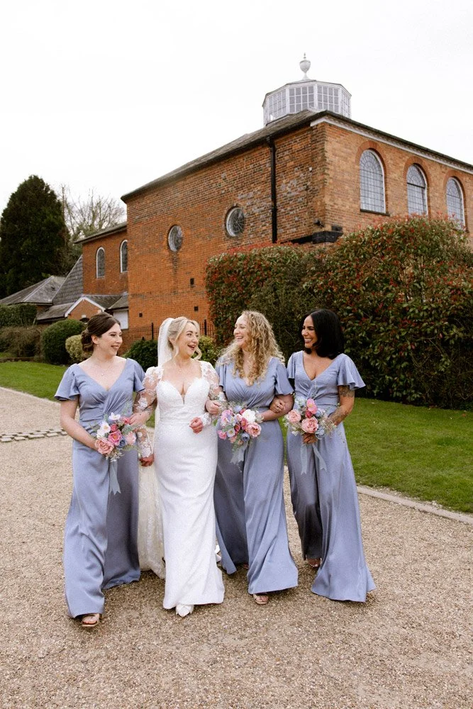 bridesmaids-walking-at-wedding-venue.jpg
