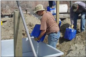 Wildlife water guzzler installation.